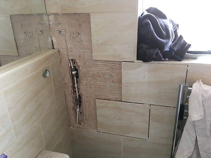 drilled tiles being repaired by DSB Plumbing and Heating services in Devon